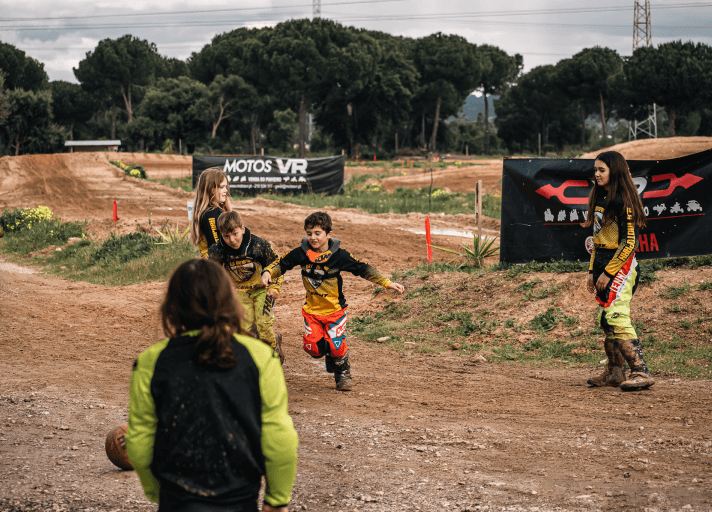 Kids riding on the motocross track during camp