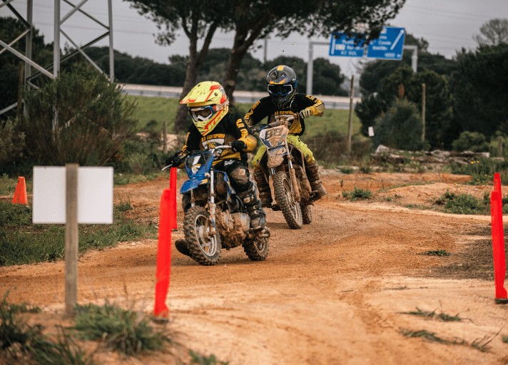 Young rider navigating a tight turn on the motocross track
