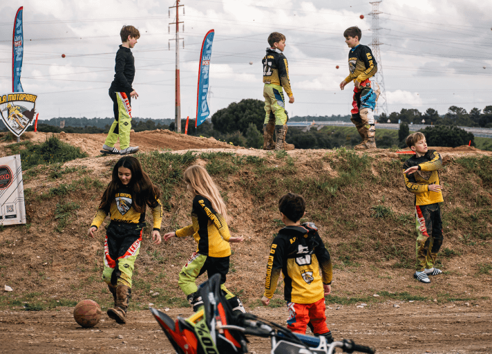 Kids preparing for motocross practice at summer camp