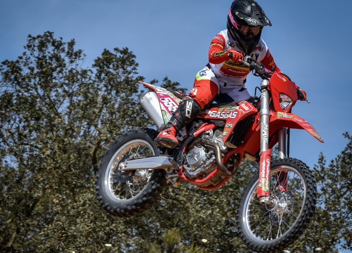 Female national motocross champion of Portugal holding the portuguese flag