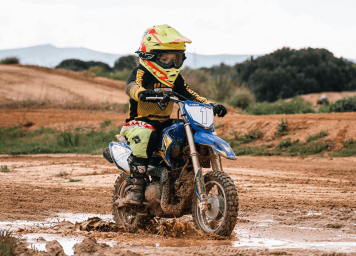 Child rider practicing motocross with Bruna Antunes